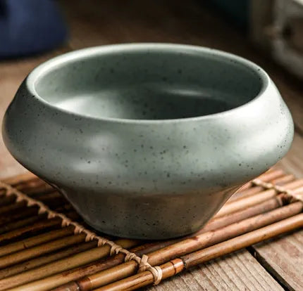 Tall porcelain Japanese soup bowl with stone conch shape and underglaze retro pattern.