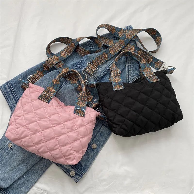 Simple shoulder messenger bag in Oxford cloth shown in multiple colours with embroidery detail and outer sandwich pocket.