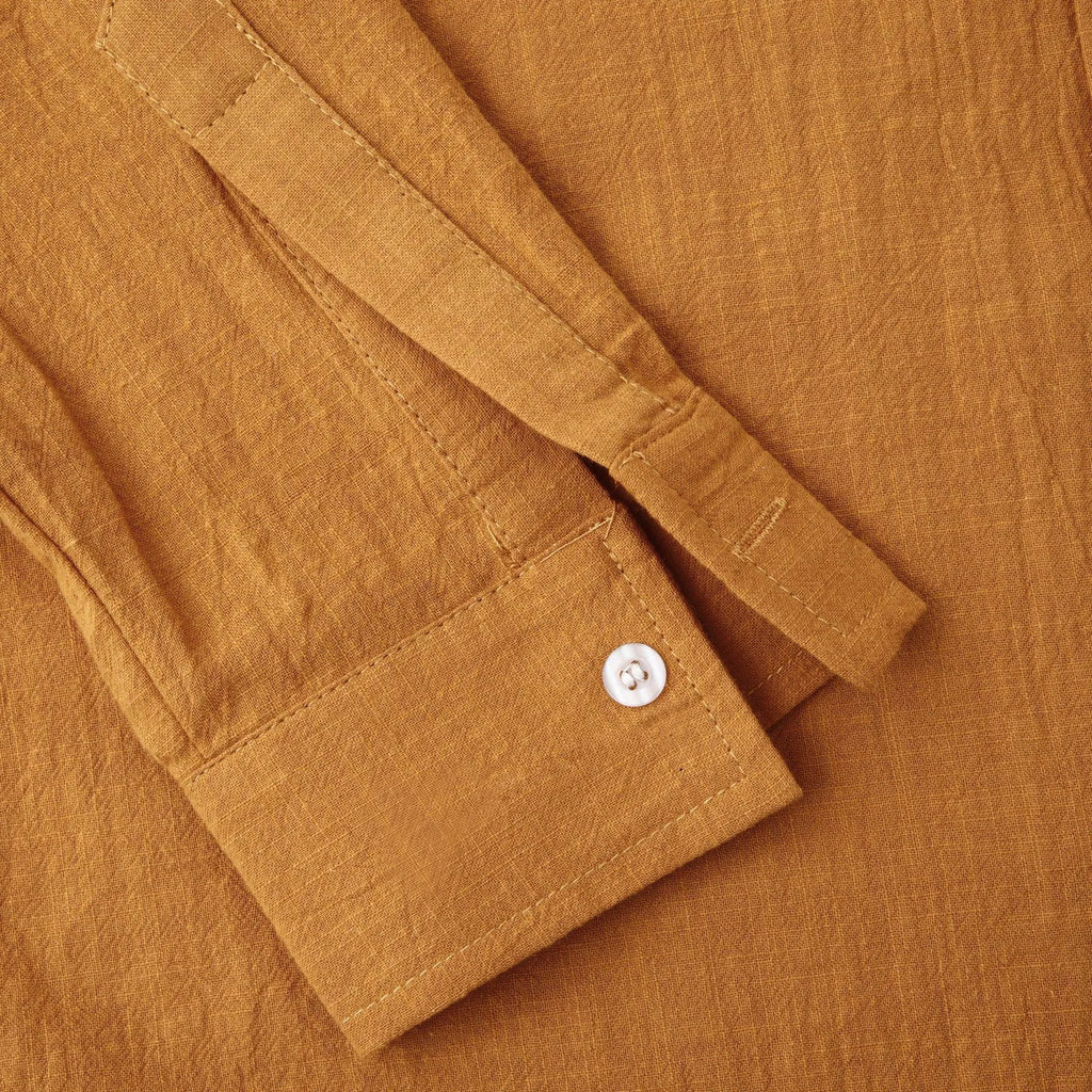Men's slim-fit brown cotton blend long sleeve shirt and matching casual trousers laid flat.