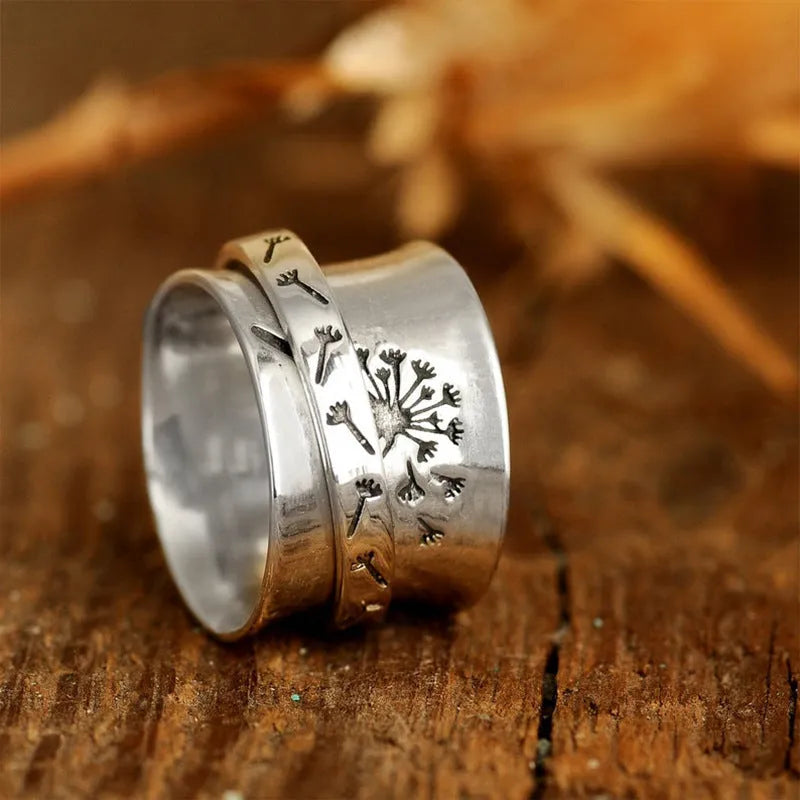 Silver rotatable flower fashion ring showing floral design and adjustable element