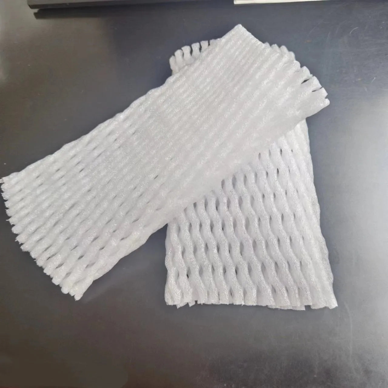 White foam fruit protection nets showing different sizes for apples, pears and peaches