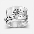 Silver rotatable flower fashion ring showing floral design and adjustable element