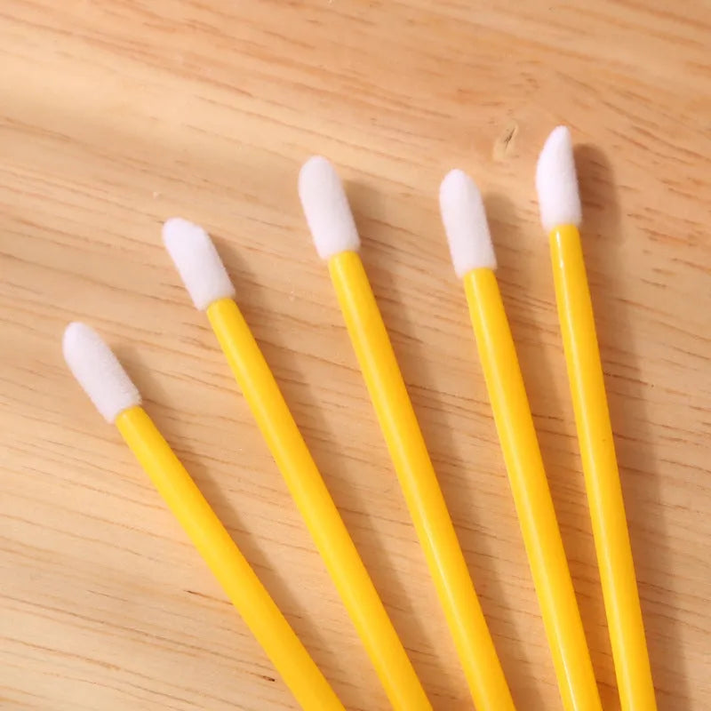 Disposable lip brushes with black handles and flocked tips in bulk packaging for lipstick and gloss application