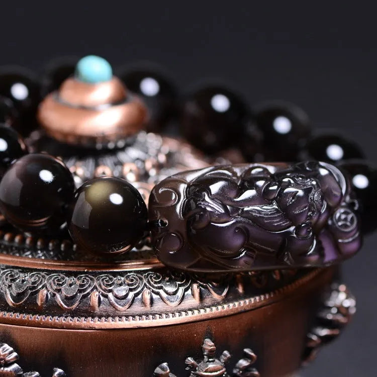Geometric Pi Xiu charm on a polished icy obsidian crystal bracelet for men and women.