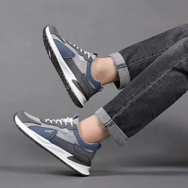 Men's colour block lace-up sneakers in grey with mesh upper and white sole.