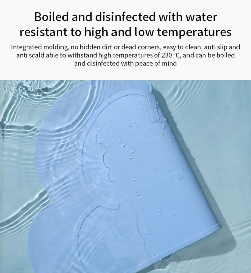 Blue silicone waterproof pet feeding mat for dog or cat food bowls on a wooden floor.