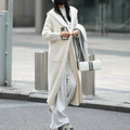 Long grey hooded knitted cardigan with a trench coat style on a hanger
