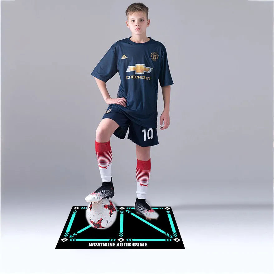 Black rectangular football training mat with non-slip surface measuring 60cm by 90cm