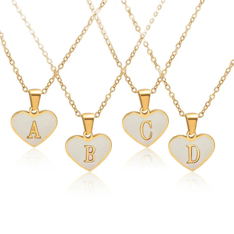 Gold-plated heart necklace with white shell accent and personalised letter pendant on stainless steel chain
