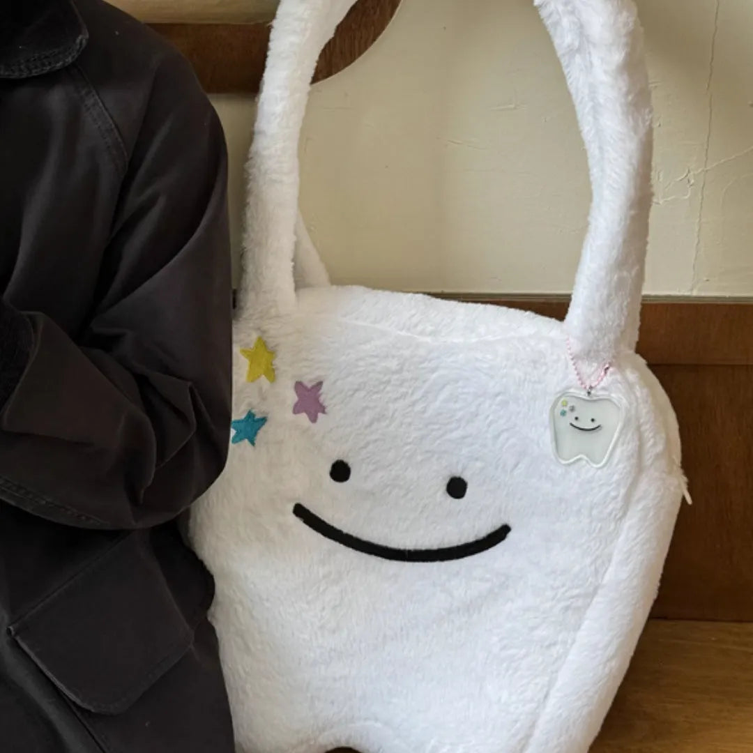 White plush large tooth shoulder tote bag with zip opening shown as crossbody carry