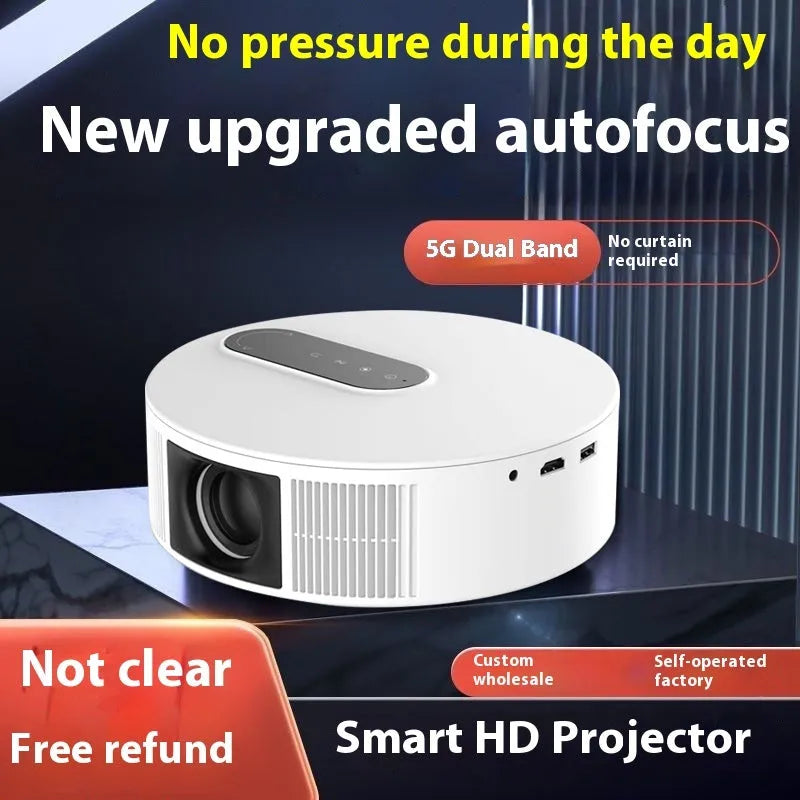 White HD home cinema projector with remote control on a wooden surface.