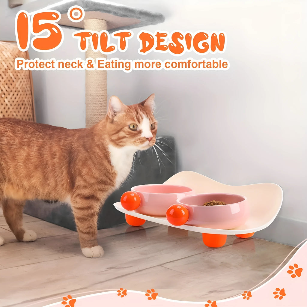 Pink ceramic double pet bowl set with raised non-slip base for cat food and water.
