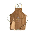 Canvas cross-back apron in camel colour on a mannequin, showing adjustable neck and waist ties
