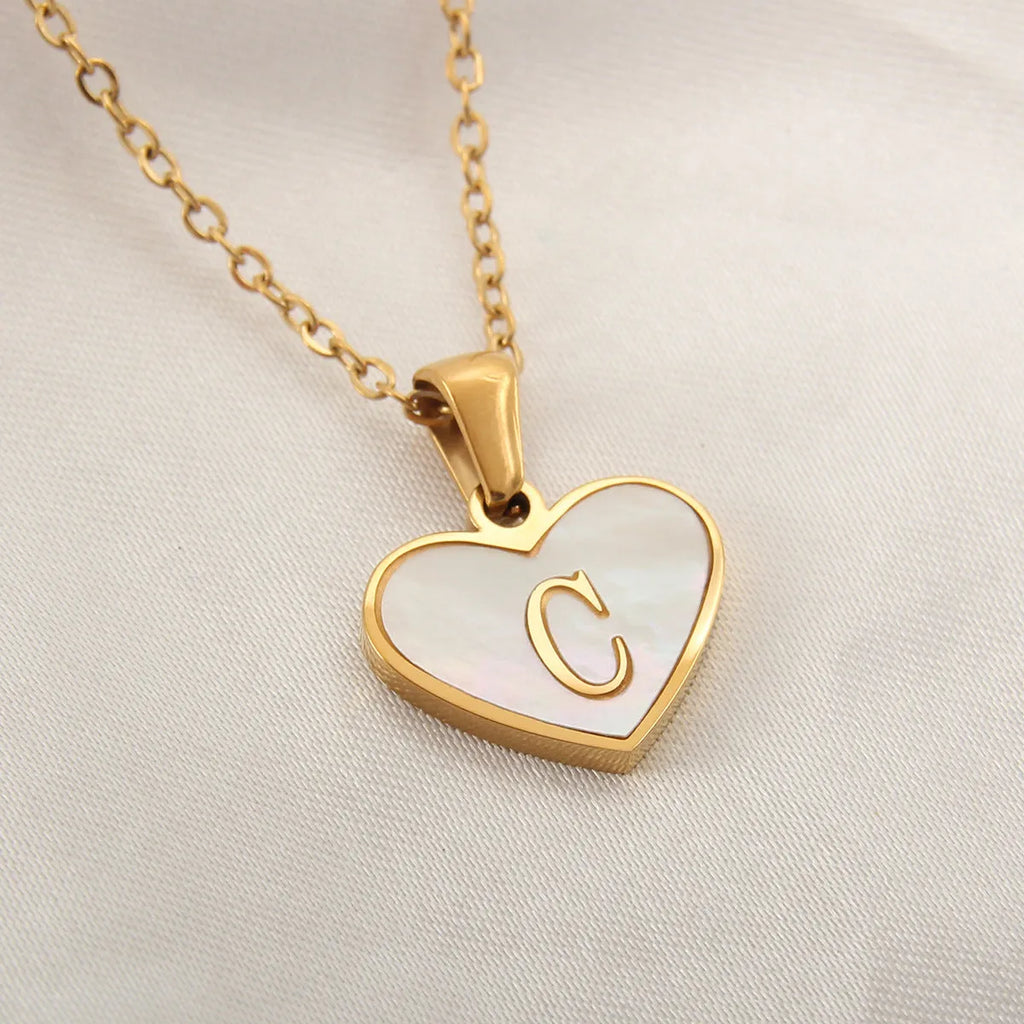 Gold-plated heart necklace with white shell accent and personalised letter pendant on stainless steel chain