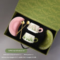 Ceramic coffee cup and saucer set for two with couple's design and stirring spoons