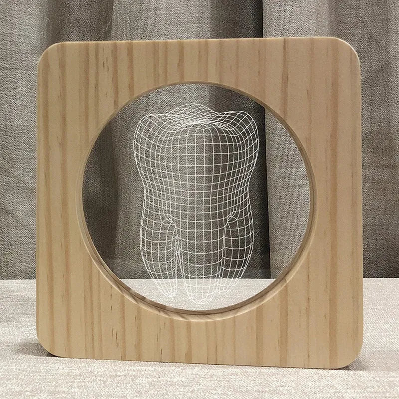 Tooth-shaped wood colour acrylic table lamp with USB cable on a wooden surface.