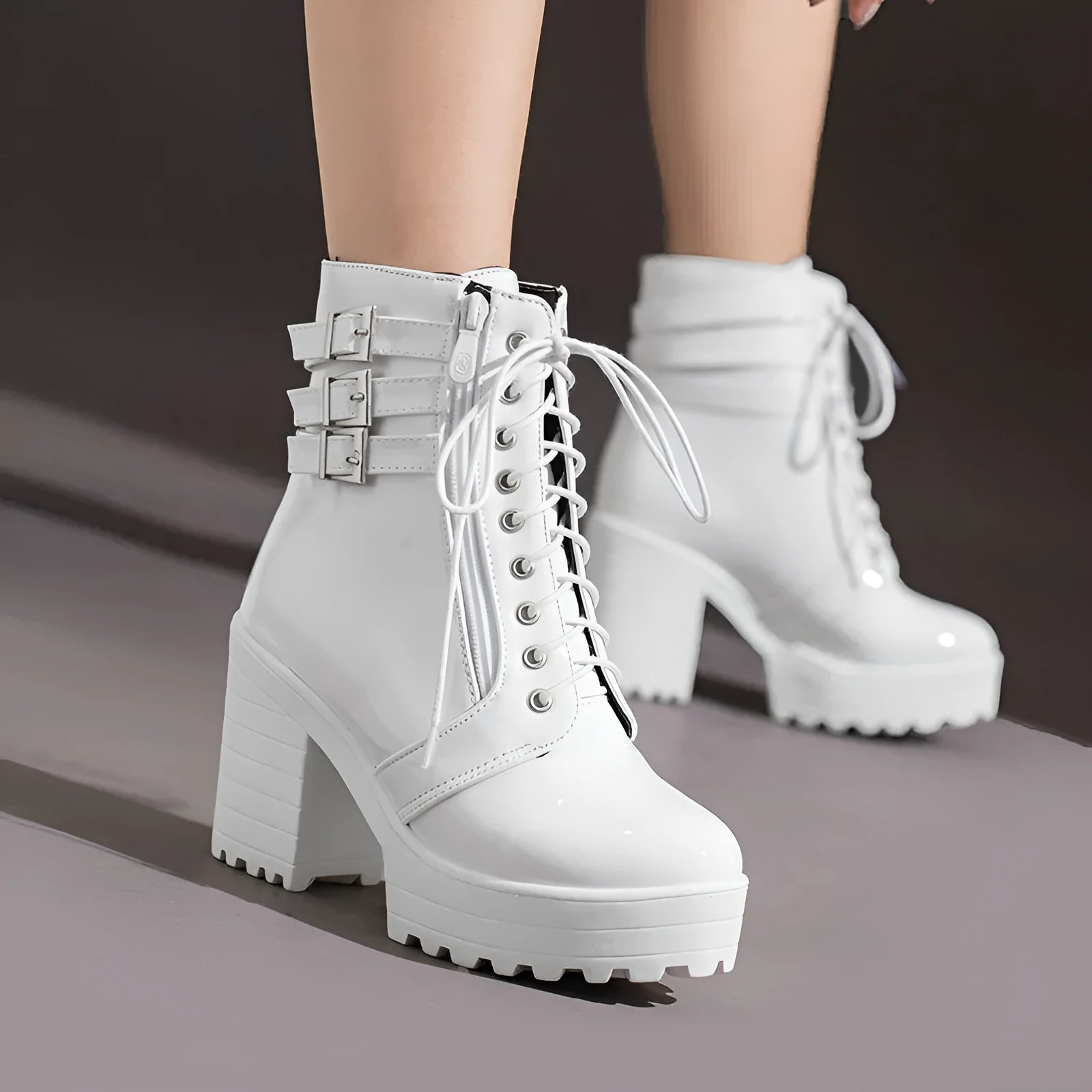 Women's black chunky heel ankle boots with front lace-up and round toe on a waterproof rubber sole.