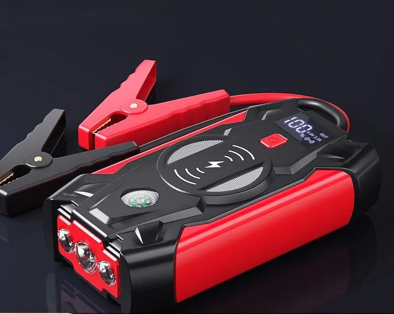 Red portable car emergency jump starter with digital display and thick clamps for 12V vehicle battery rescue