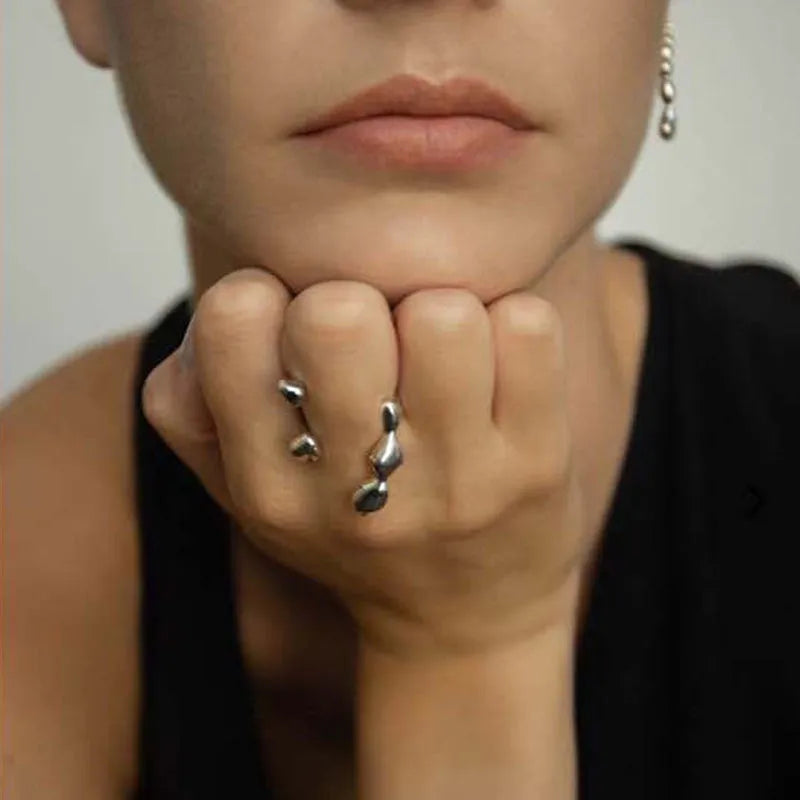 Brass adjustable fashion ring with spherical detail in gold or silver finish.