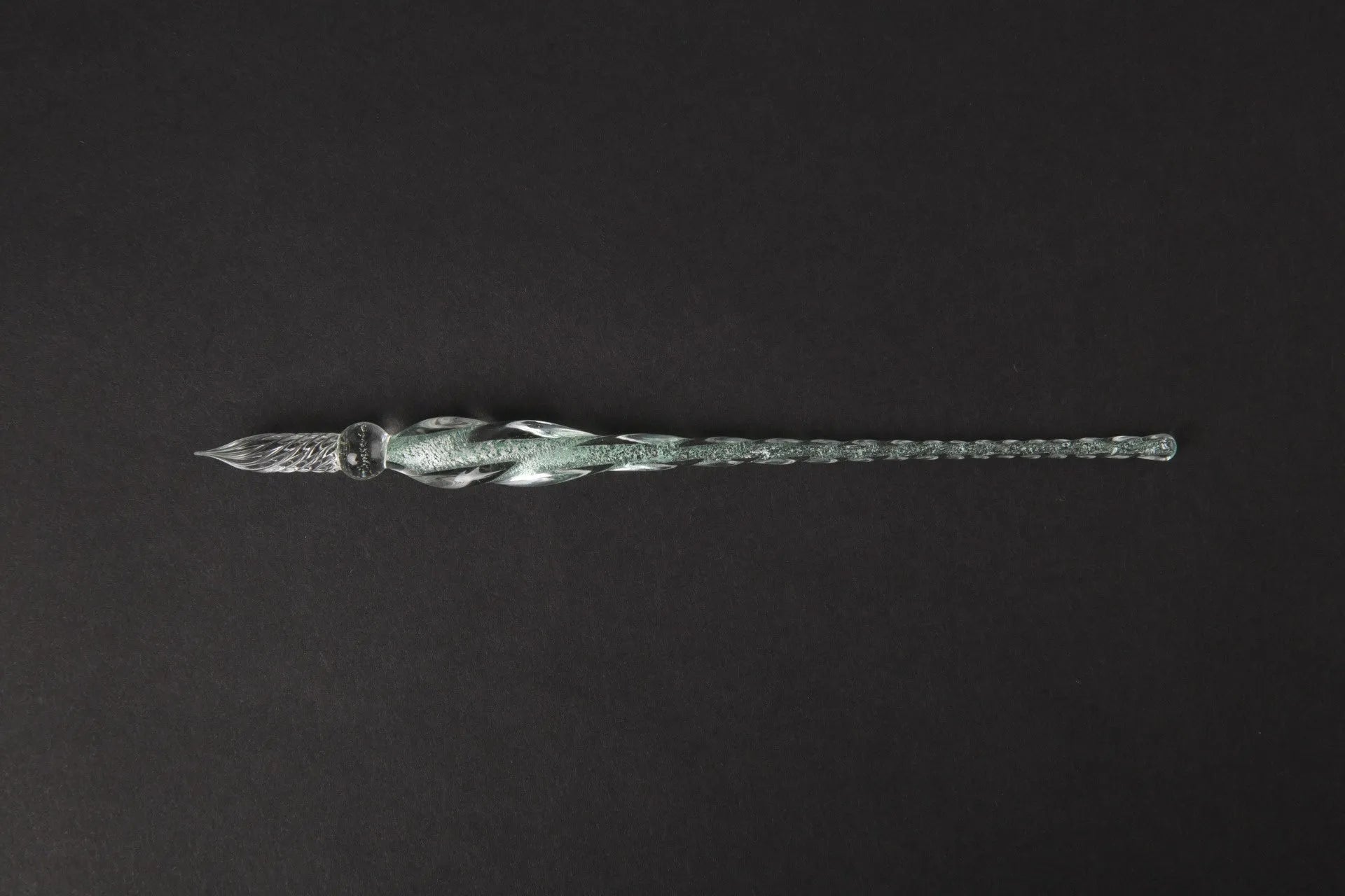 Transparent glass crystal pen with coloured ink visible inside, abstract modelling design