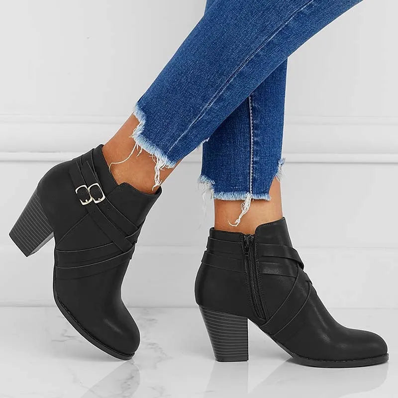 Plus size women's short ankle boots with a 7cm block heel, side zipper, and belt buckle detail in black.