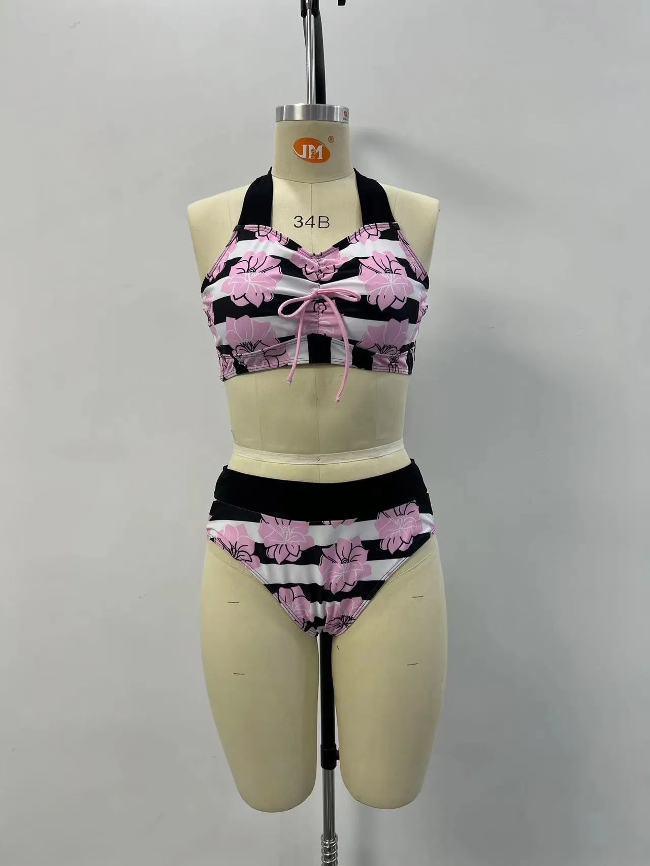 Black printed women's bikini with slimming belly panel and split-leg bottoms.