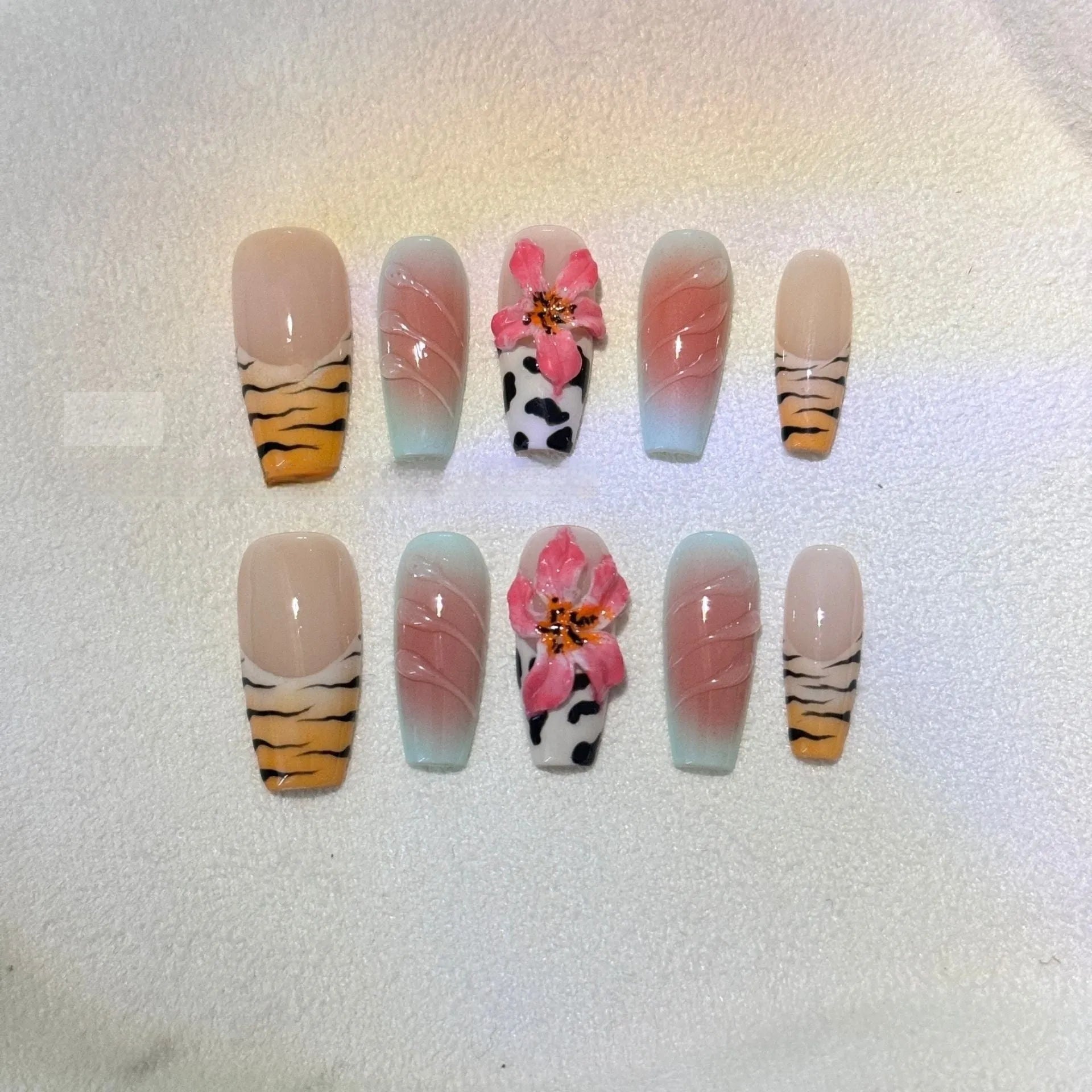 Hand carved zebra pattern nail art with embossed flower and leopard print designs in four size options