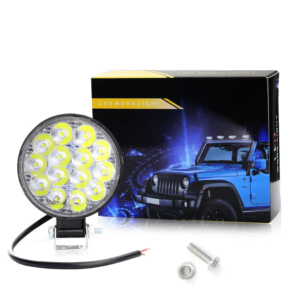 White mini round 42W LED work light with aluminium housing for vehicle mounting.