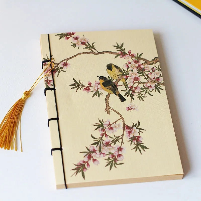 A5 antique wire-bound notebook with retro painting cover, thread binding, and black tassels.