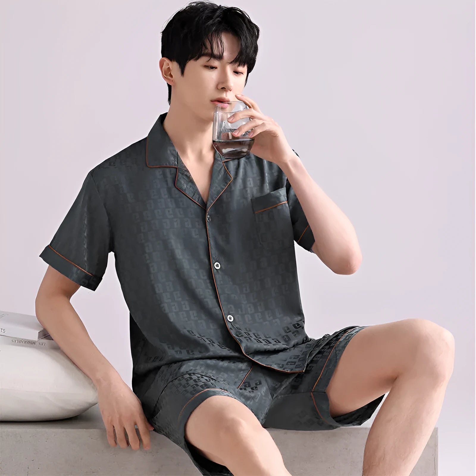 Men's black and white plaid ice silk pajama set with cardigan top and shorts on a hanger.