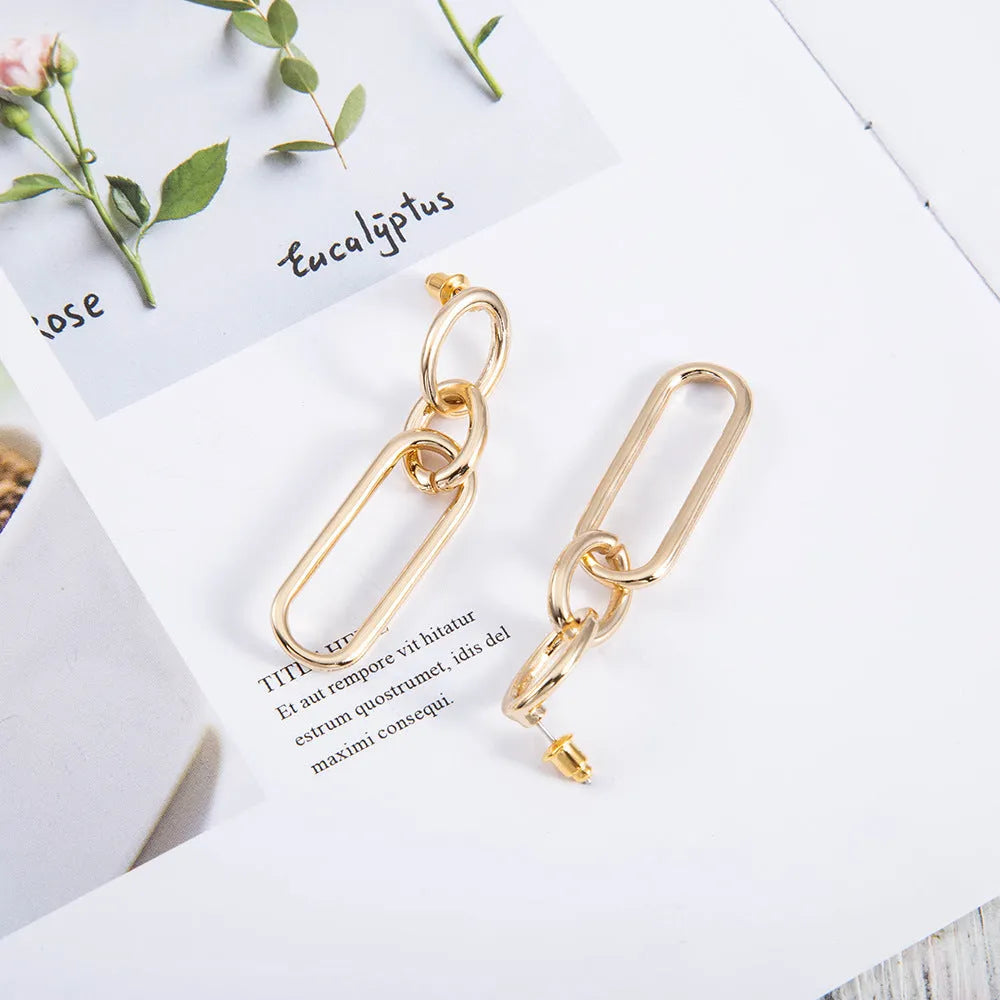 Sterling silver geometric hoop earrings with needle posts and ring-line design