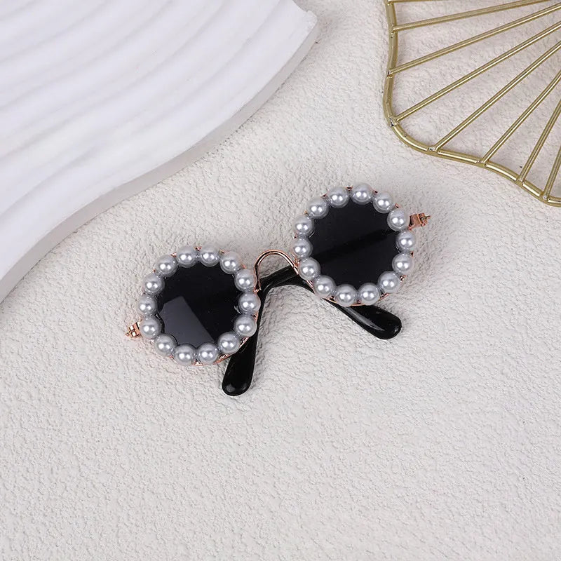 Pearl-rimmed round sunglasses on a cat and dog for costume dress up