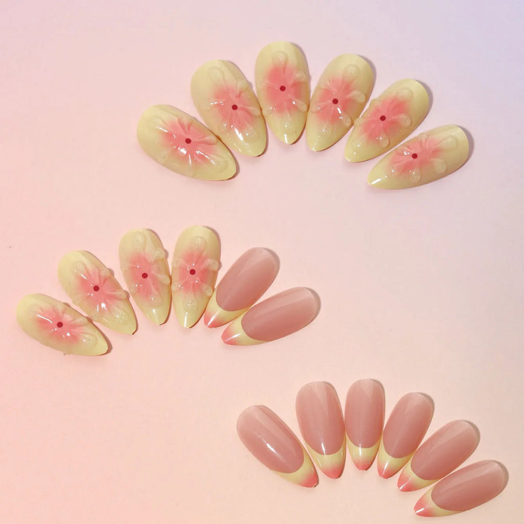 Set of pink plastic fake nails with raised 3D cartoon flower designs, jelly glue, and a nail file.