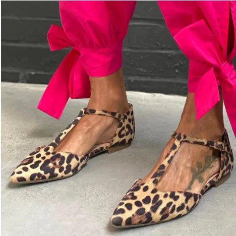 Leopard print women's pumps with pointed toe and chunky low heel featuring cross shoulder strap