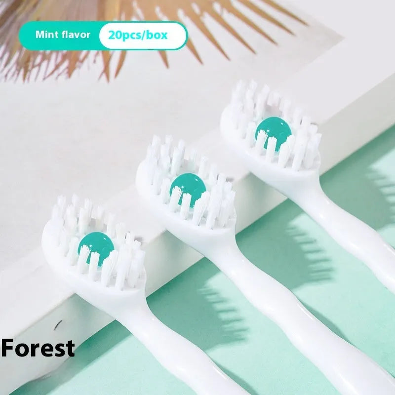Box containing 20 small white disposable bead toothbrushes with compact rounded heads for travel.