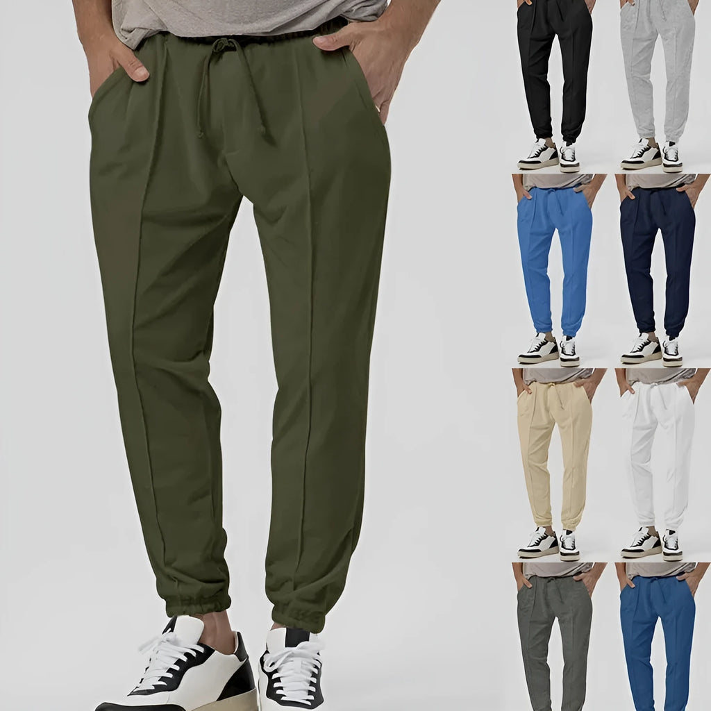 Men's grey cotton blend straight-leg track sweatpants with a mid waist and loose tapered fit on a hanger.