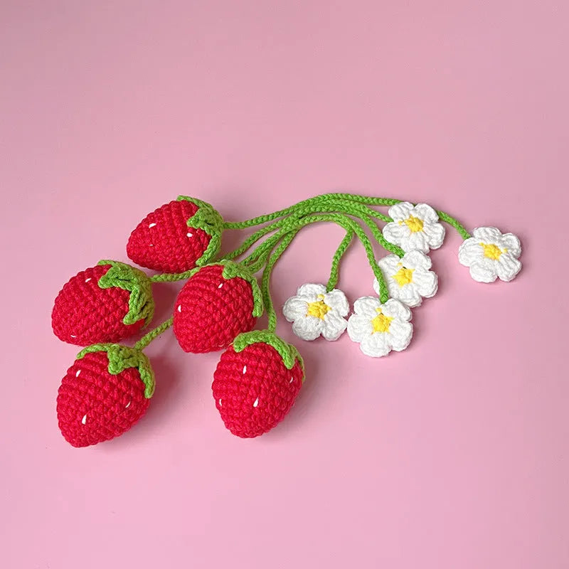 Red wool crochet strawberry pendant with a 35 cm knitted cord against a white background.