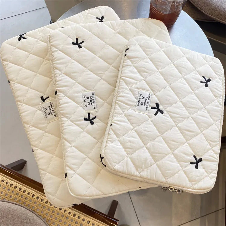 Nylon laptop storage bag with rhombus embroidery and bow in light blue, showing front detail
