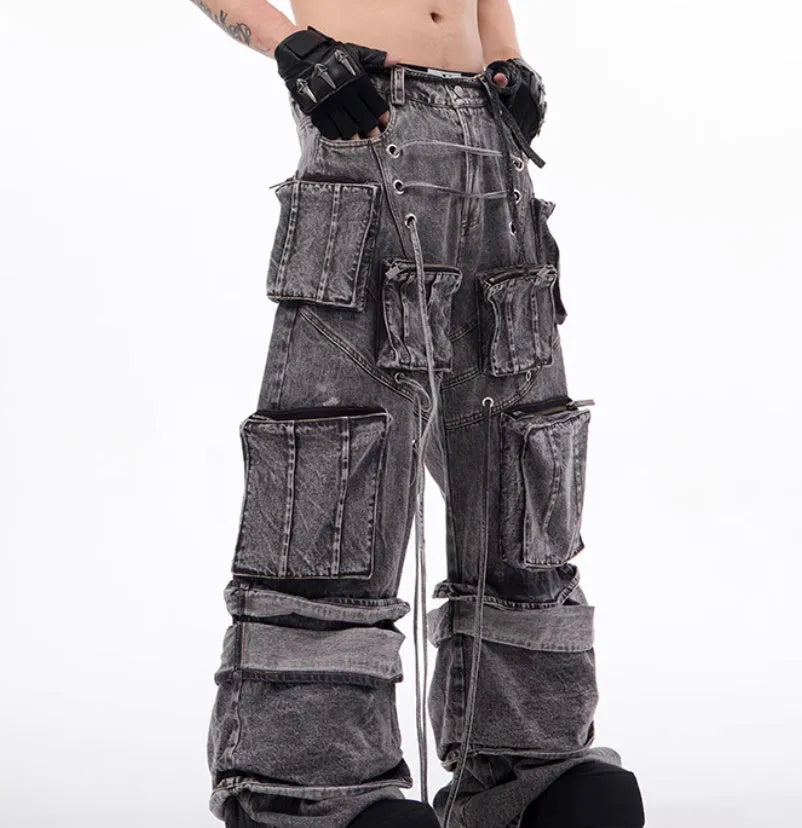 Grey distressed denim overalls with rope stitching and mop pant design on male model