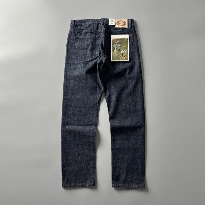 Men's straight leg denim trousers in a primary colour, showing the mid waist fit and long leg.