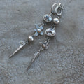 Geometric long pendant earrings with antique silver plating and rhinestone details on an XINGX design.