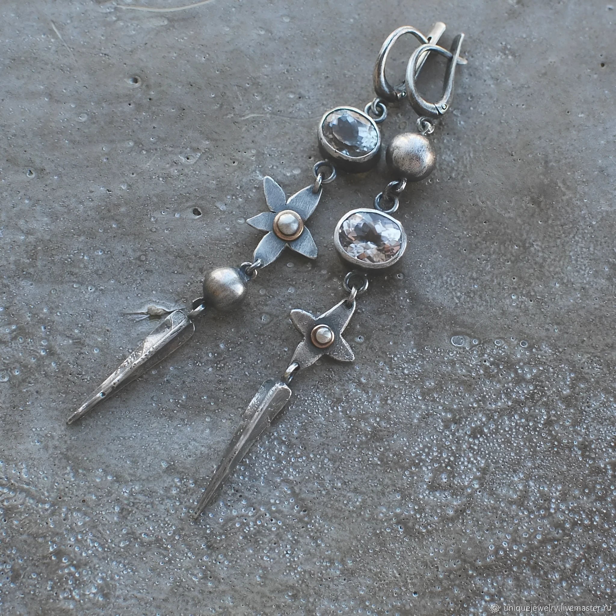 Geometric long pendant earrings with antique silver plating and rhinestone details on an XINGX design.