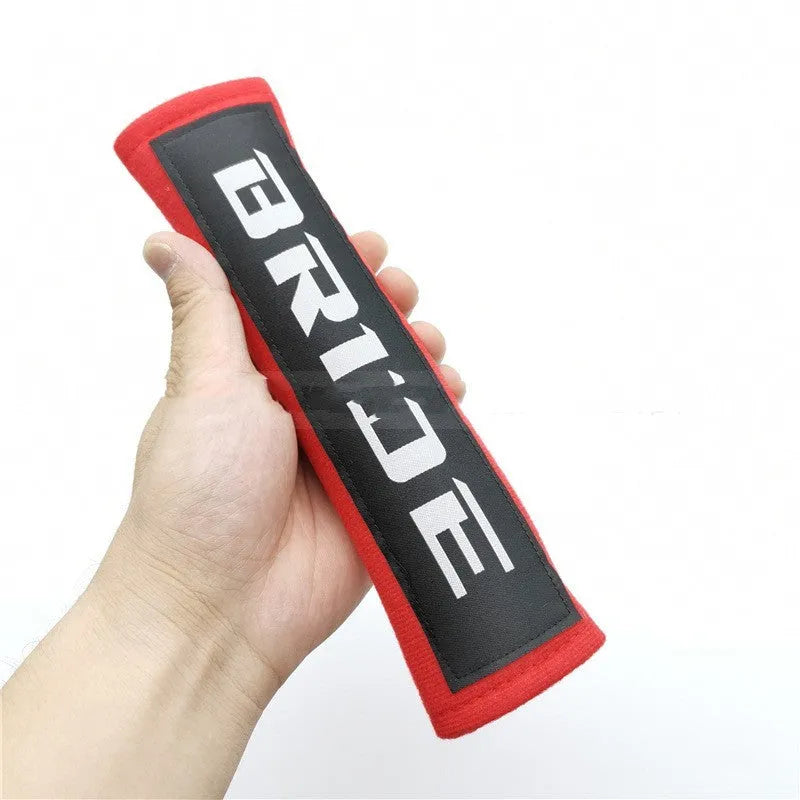 Car seatbelt shoulder pads with embroidery detail in black, blue, and red colour options