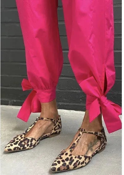 Leopard print women's pumps with pointed toe and chunky low heel featuring cross shoulder strap