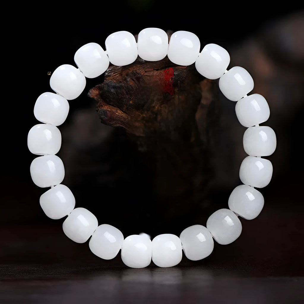 White Hetian jade barrel bead bracelet showing three size options on a neutral background