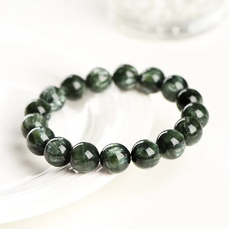 Green dragon crystal bracelet with geometric round beads showing ruyi symbolism detail
