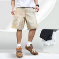 Light blue washed men's denim shorts with ripped details on a straight-leg cut
