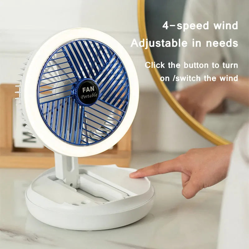 Blue foldable USB desk fan with LED light shown in open position on a table
