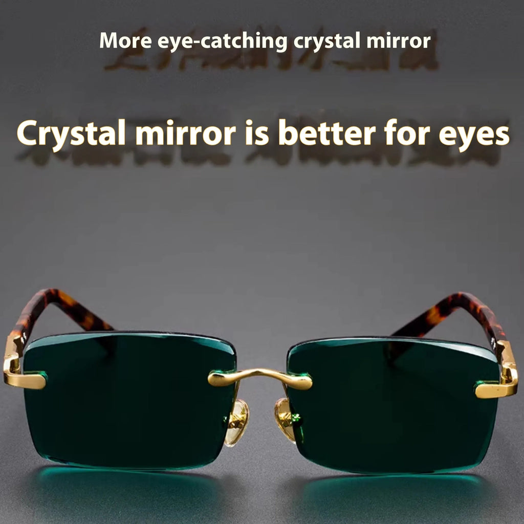 A pair of frameless sunglasses with dark green crystal lenses, shown with a soft case and cleaning cloth.