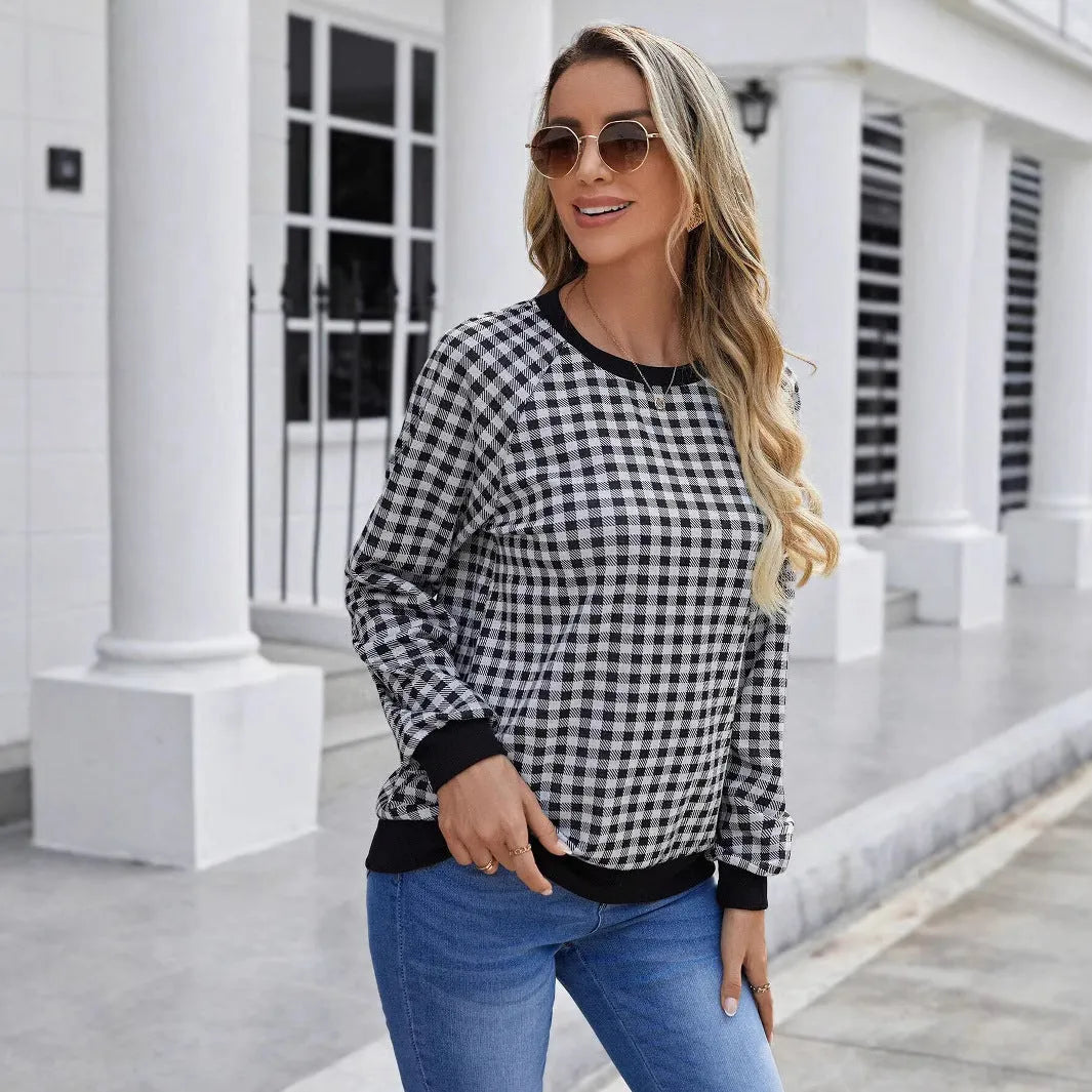 Black long sleeve pullover sweater with a Japanese plaid pattern, shown on a hanger.